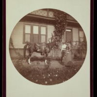 J.G. Averell, unidentified woman and horse in front of house<br />
