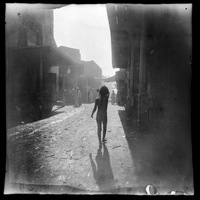 Naked child walking on narrow street, Egypt, 1892-1893