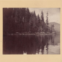 Man in boat near shore, possibly in Yellowstone Lake in Yellowstone National Park<br />
