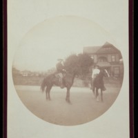 Man and boy on horses in front of house, Santa Barbara